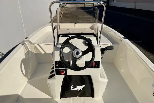 Slide: The Image of 2025 Mako Pro Skiff 17 CC boat interior with steering wheel and console. - 14