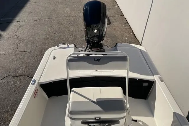 Slide: The Image of 2025 Mako Pro Skiff 17 CC boat, rear view with motor and seating. - 17