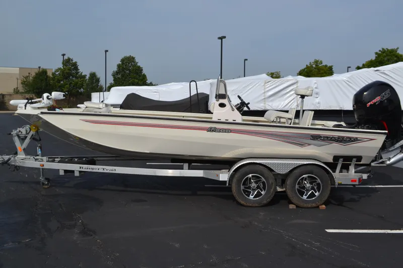 Slide: The Image of 2024 Ranger RB200 boat on trailer, parked outdoors, side view. - 0
