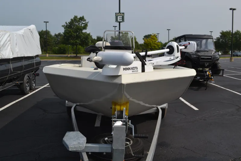 Slide: The Image of 2024 Ranger RB200 boat with Minn Kota Maxxum motor in a parking lot. - 2