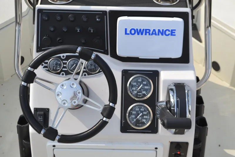 Slide: The Image of 2024 Ranger RB200 boat dashboard with steering wheel, gauges, and Lowrance navigation system. - 3