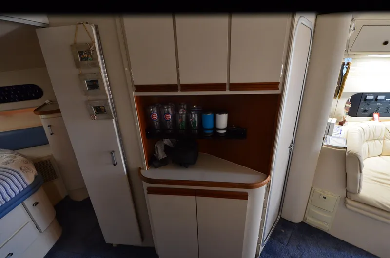 Slide: The Image of Interior of 1989 Carver SANTEGO yacht with cabinets and seating area. - 25