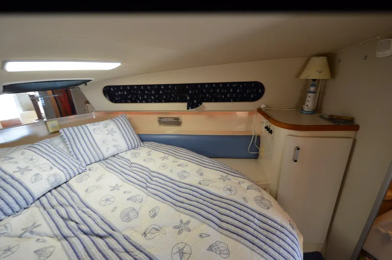 Slide: The Image of Cozy cabin interior of 1989 Carver SANTEGO with nautical-themed bedding and decor. - 28