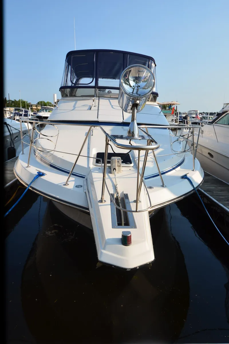 Slide: The Image of 1989 Carver SANTEGO yacht docked, front view with clear blue sky. - 30