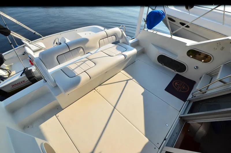 Slide: The Image of 1989 Carver SANTEGO boat deck with white seating and open water view. - 7