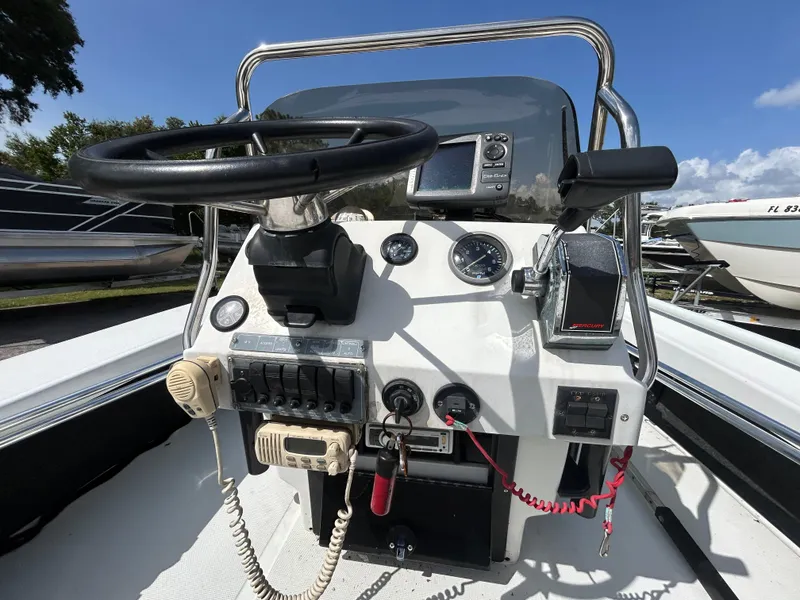 Slide: The Image of 1998 Action Craft 1820 Special Edition boat console with steering wheel and controls. - 10