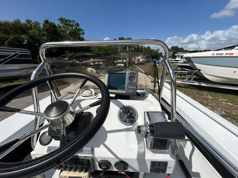 Slide: The Image of 1998 Action Craft 1820 Special Edition boat dashboard with steering wheel and navigation equipment. - 11