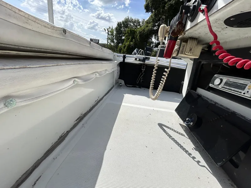 Slide: The Image of 1998 Action Craft 1820 Special Edition boat interior with radio and coiled cord. - 13