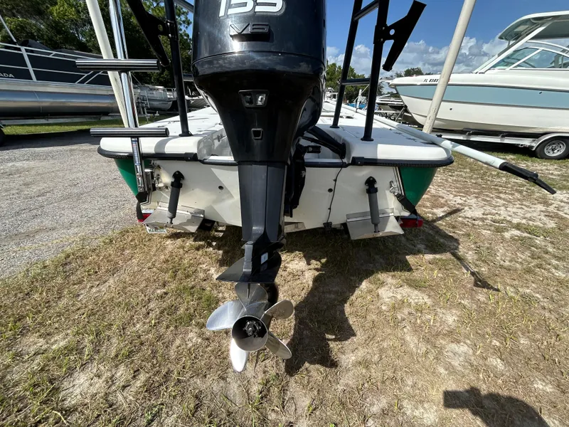 Slide: The Image of 1998 Action Craft 1820 Special Edition boat with outboard motor, parked on grass. - 15