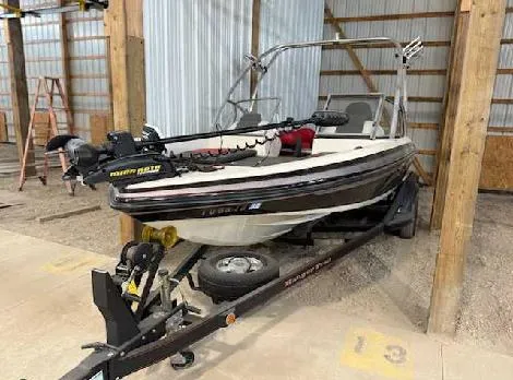 Slide: The Image of 2009 Ranger 211 Reata boat on trailer in storage shed. - 0
