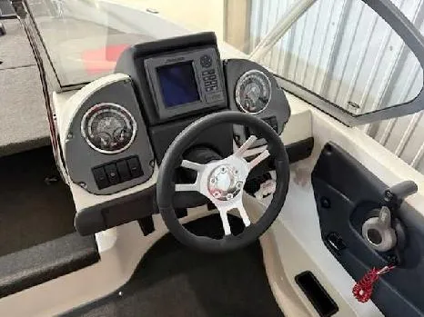 Slide: The Image of 2009 Ranger 211 Reata boat dashboard with steering wheel and gauges. - 4