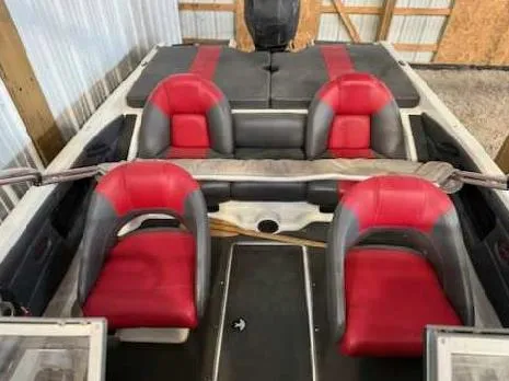 Slide: The Image of 2009 Ranger 211 Reata boat interior with red and gray seating in a storage area. - 7