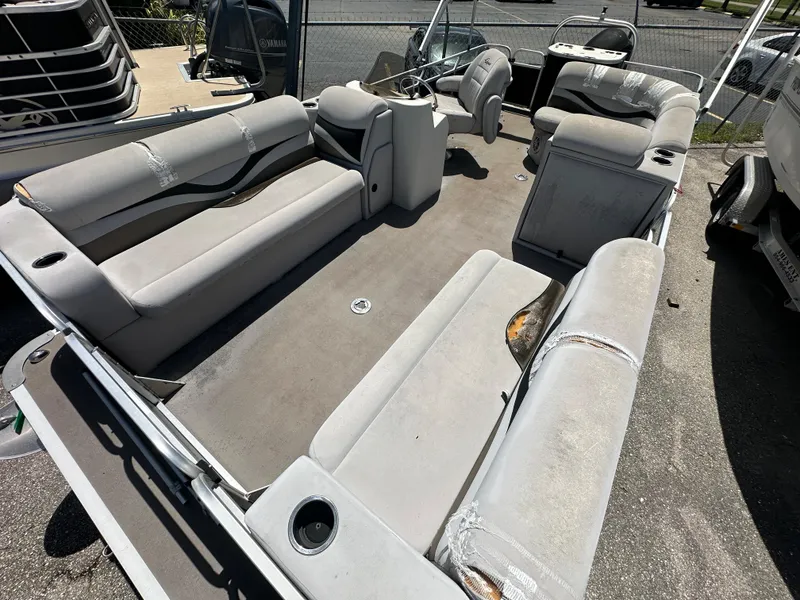 Slide: The Image of 2016 Qwest LS 820 Cruise pontoon boat interior with worn seating and steering console. - 10