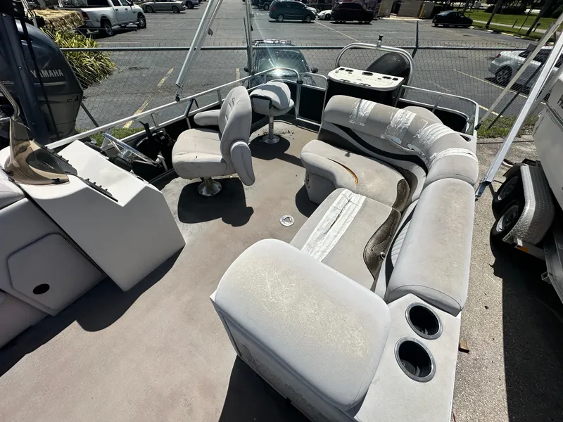 Slide: The Image of 2016 Qwest LS 820 Cruise pontoon boat interior with worn seating and Yamaha engine. - 11