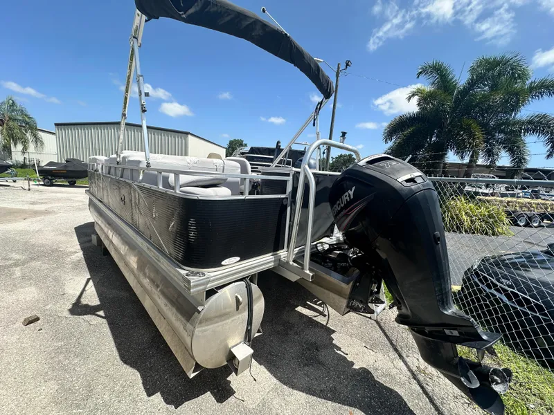 Slide: The Image of 2016 Qwest LS 820 Cruise pontoon boat with Mercury outboard motor, parked outdoors. - 8