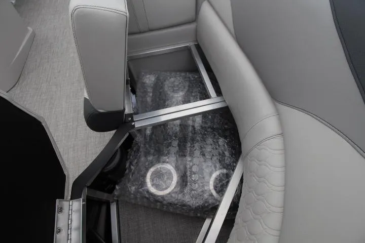 Slide: The Image of 2025 Avalon LSZ Quad Lounger Shift interior storage compartment with bubble-wrapped items. - 12