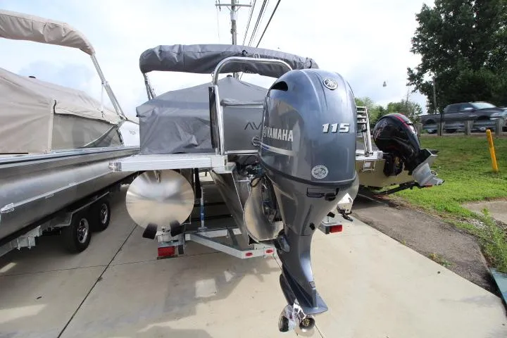Slide: The Image of 2025 Avalon LSZ Quad Lounger Shift pontoon boat with Yamaha 115 outboard motor. - 2