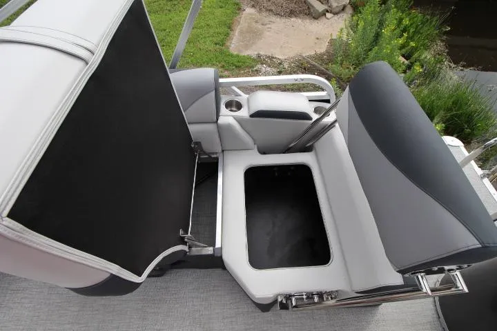 Slide: The Image of 2025 Avalon LSZ Quad Lounger Shift boat seat with storage compartment open. - 8