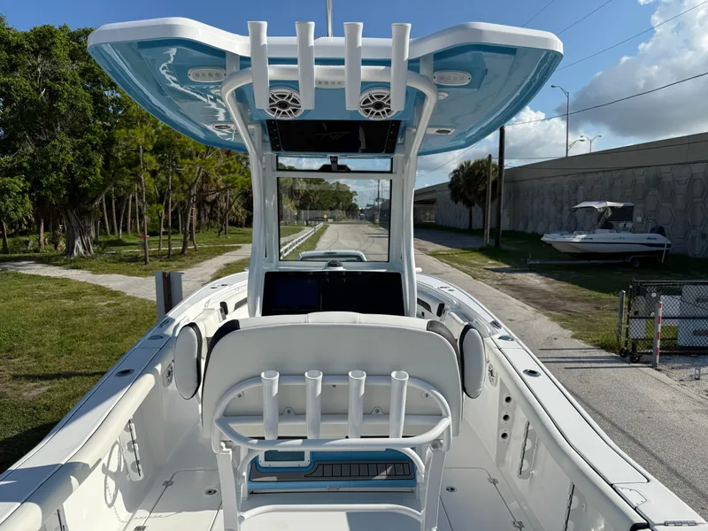 Slide: The Image of 2026 Tidewater 256 LXF boat interior with modern helm and seating, docked outdoors. - 3