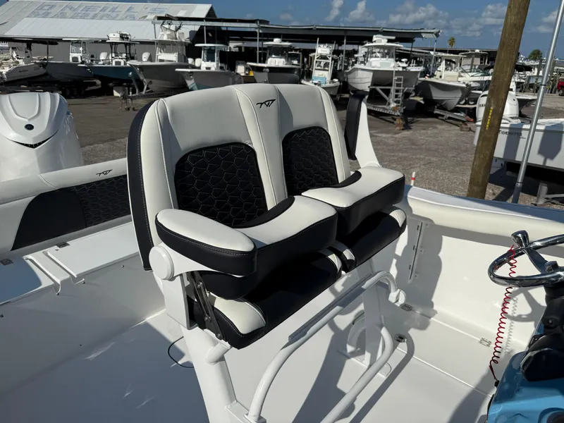 Slide: The Image of 2026 Tidewater 256 LXF boat interior with dual seats and steering wheel. - 7