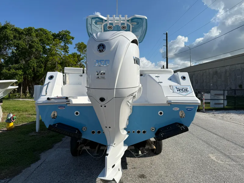 Slide: The Image of 2026 Tidewater 256 LXF boat with Yamaha 350 V8 engine, parked outdoors. - 9