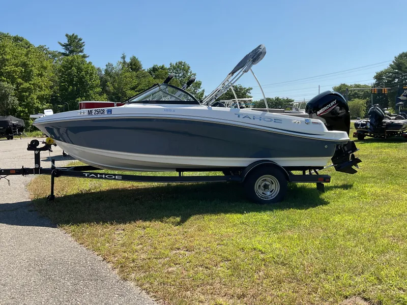 Slide: The Image of 2023 Tahoe 185 S boat on trailer, parked on grass, sunny day. - 3