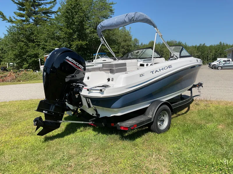 Slide: The Image of 2023 Tahoe 185 S boat on trailer with Mercury engine, parked on grass. - 6