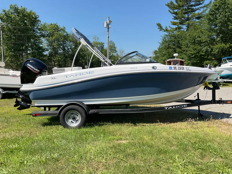 Slide: The Image of 2023 Tahoe 185 S boat on trailer, parked on grass, with Mercury outboard motor. - 7