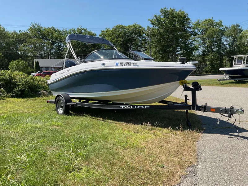 Slide: The Image of 2023 Tahoe 185 S boat on trailer, parked on grass, sunny day. - 8
