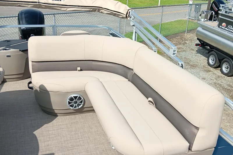 Slide: The Image of 2025 Sun Tracker Bass Buggy 18 DLX pontoon boat with beige seating and speaker system. - 10
