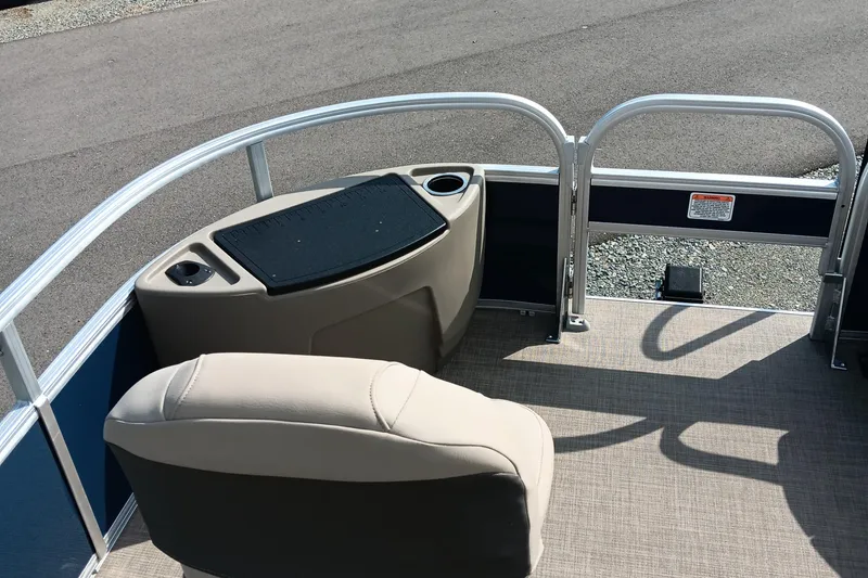 Slide: The Image of 2025 Sun Tracker Bass Buggy 18 DLX pontoon boat interior with seating and console. - 5