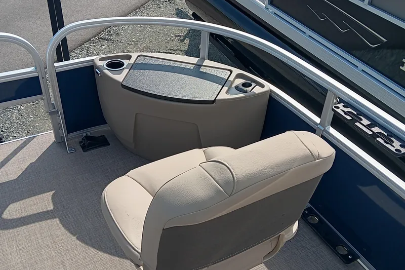 Slide: The Image of 2025 Sun Tracker Bass Buggy 18 DLX boat interior with beige seating and cup holders. - 6