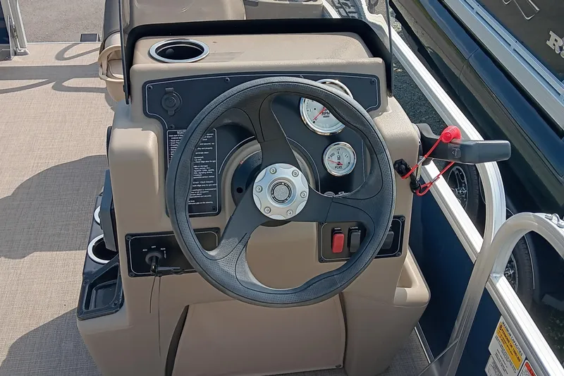 Slide: The Image of 2025 Sun Tracker Bass Buggy 18 DLX steering console with gauges and controls. - 7