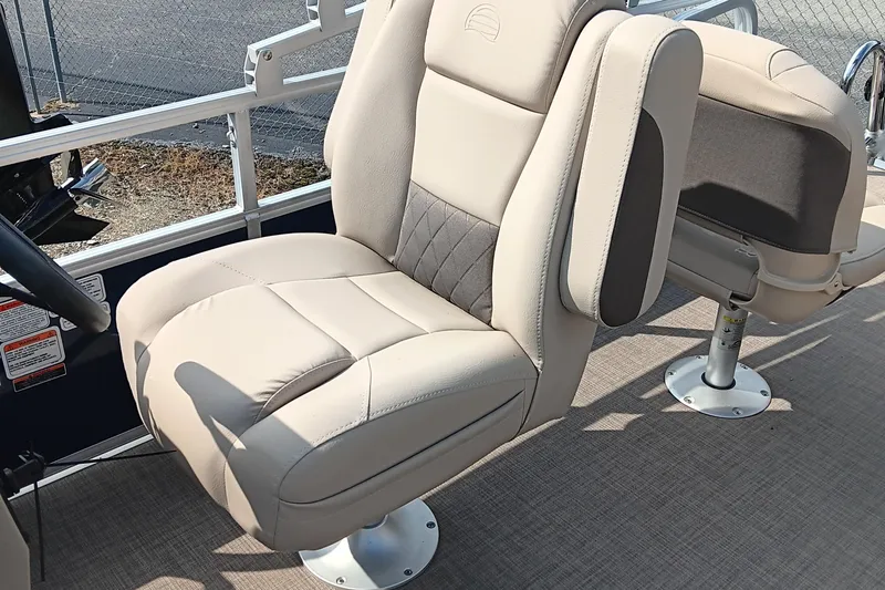 Slide: The Image of 2025 Sun Tracker Bass Buggy 18 DLX boat seat, beige upholstery, outdoor setting. - 8