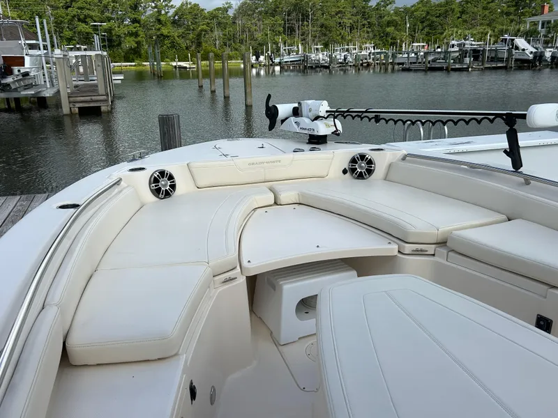 Slide: The Image of 2023 Grady-White 281 Coastal Explorer boat interior with cushioned seating and water view. - 13