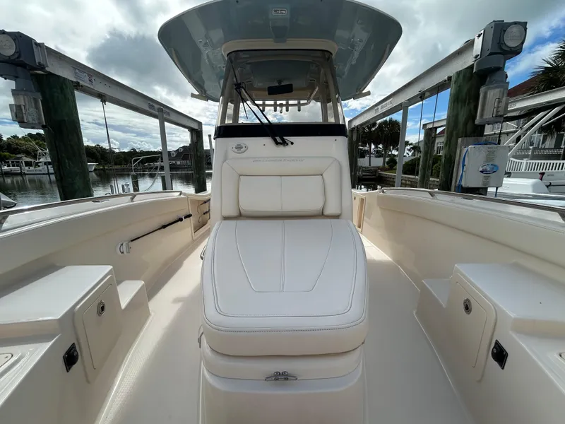 Slide: The Image of 2023 Grady-White 281 Coastal Explorer boat interior with white seating and helm station. - 14