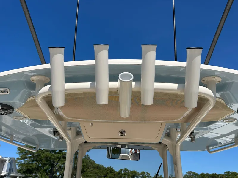 Slide: The Image of 2023 Grady-White 281 Coastal Explorer boat with rod holders against clear blue sky. - 17