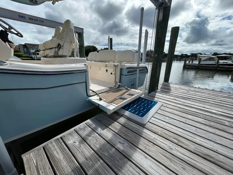 Slide: The Image of 2023 Grady-White 281 Coastal Explorer docked, showcasing sleek design and spacious seating. - 2