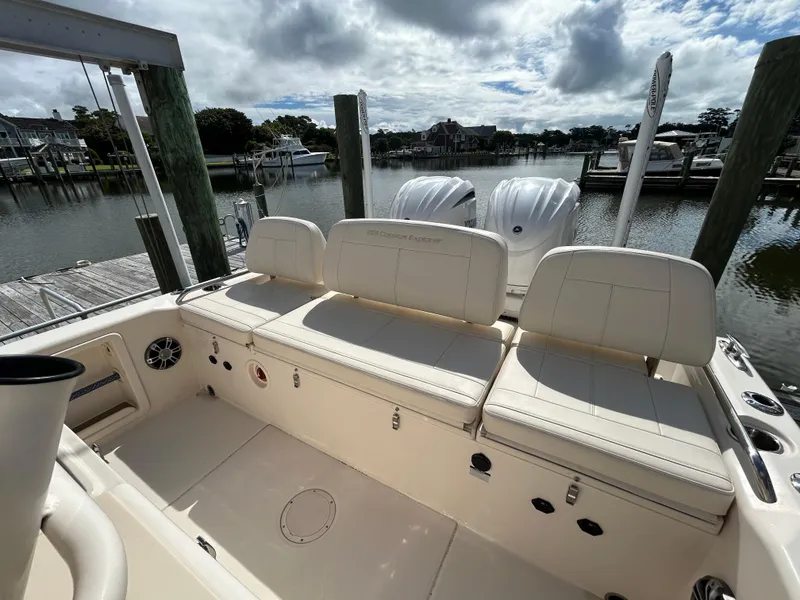 Slide: The Image of 2023 Grady-White 281 Coastal Explorer boat interior with seating, docked by the water. - 3