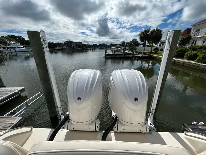 Slide: The Image of 2023 Grady-White 281 Coastal Explorer boat with dual engines docked in a scenic marina. - 7