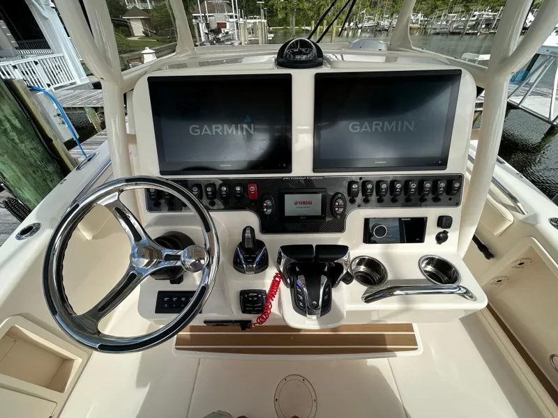 Slide: The Image of 2023 Grady-White 281 Coastal Explorer helm with dual Garmin displays and Yamaha controls. - 9