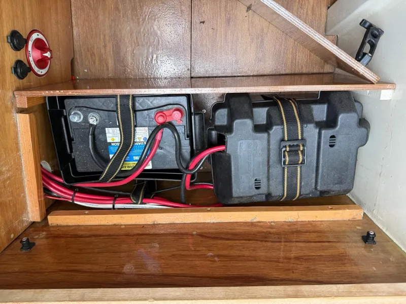 Slide: The Image of Battery compartment of AREY's XFC-22, 2022 model, with red and black cables. - 14