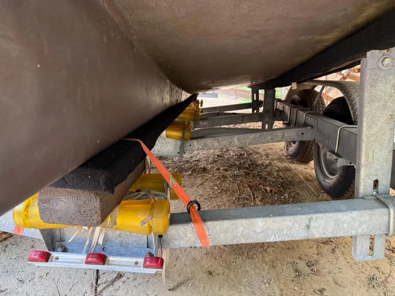 Slide: The Image of Trailer underside of Custom AREY's XFC-22, 2022 model, with support beams and wheels. - 15