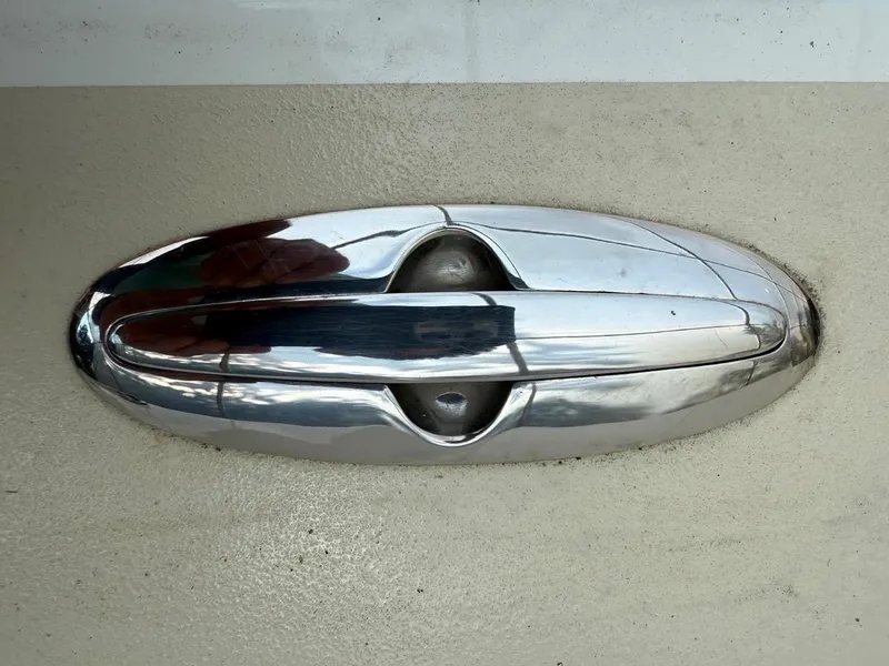 Slide: The Image of Chrome door handle on AREY's XFC-22, 2022 model, against a beige background. - 16