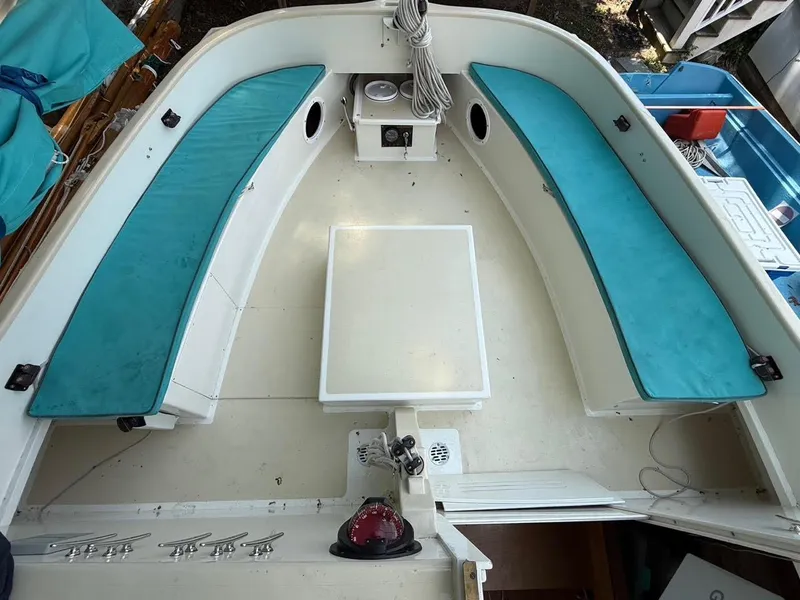 Slide: The Image of Interior of 2022 AREY's XFC-22 boat with teal seating and central table. - 23