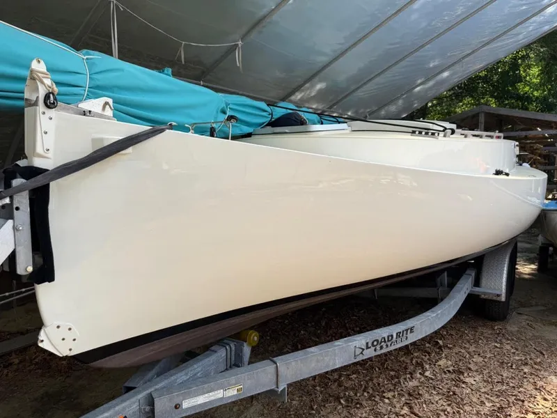 Slide: The Image of Custom AREY's XFC-22 sailboat on trailer, 2022 model, under a canopy. - 24