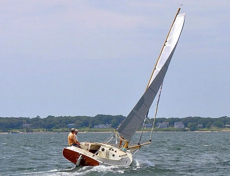 Slide: The Image of Sailboat AREY's XFC-22 navigating ocean waters, 2022 model, with scenic coastal background. - 9