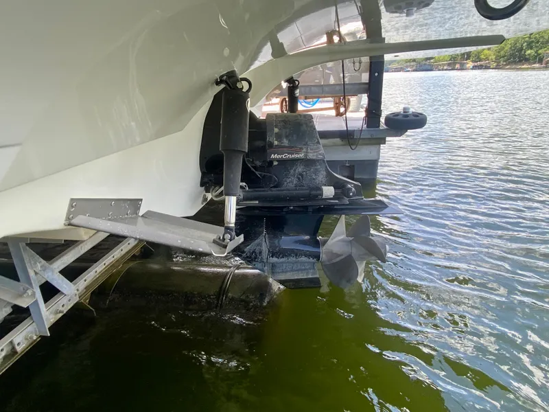 Slide: The Image of 2008 Rinker 246 Captiva Bowrider boat stern with propeller in water. - 11