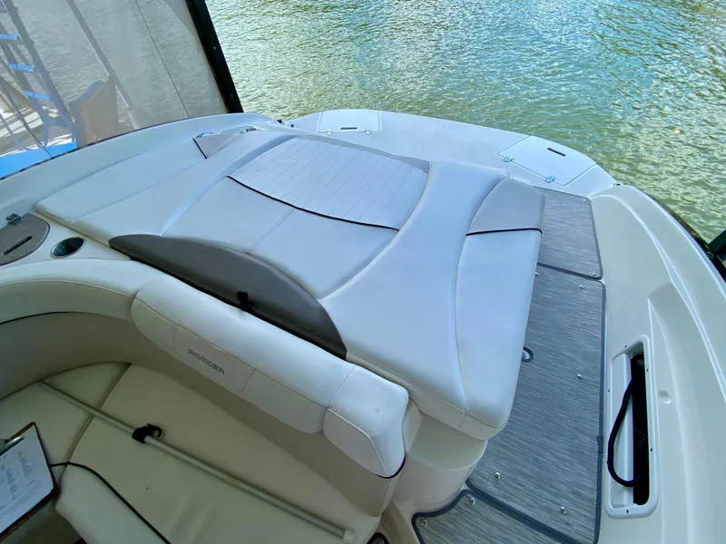 Slide: The Image of 2008 Rinker 246 Captiva Bowrider interior with cushioned seating and water view. - 13