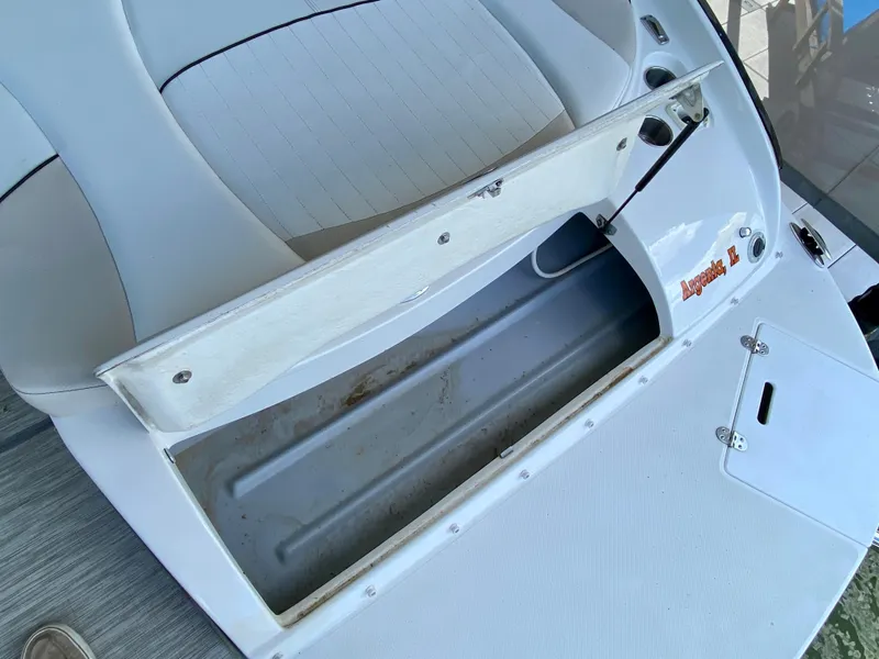 Slide: The Image of 2008 Rinker 246 Captiva Bowrider storage compartment open, showcasing interior space. - 15
